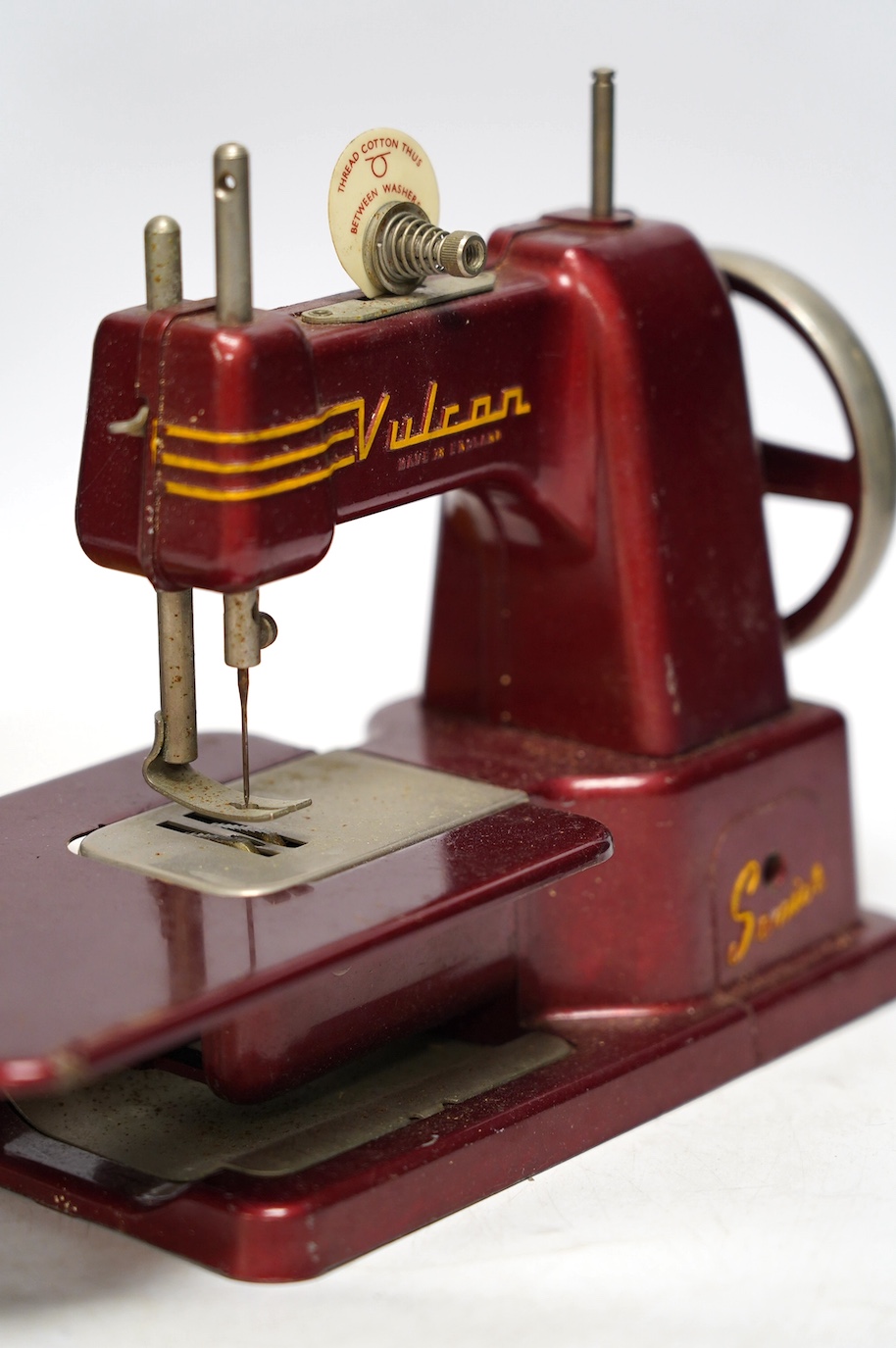 Two mid 20th century child’s sewing machines including a Vulcan Senior sewing machine in metallic red finish. Condition - fair